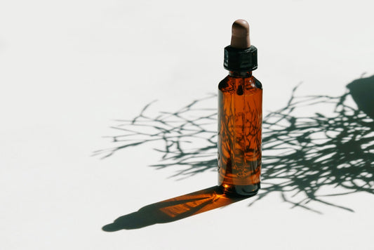 Brown Glass Bottle on White Surface