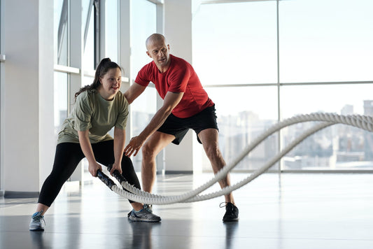 A Woman Holding Ropes Beside a Trainer