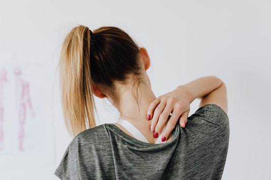 woman rubbing her neck muscle
