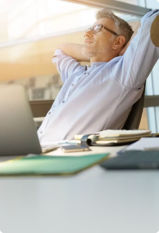 An image of a man smiling and leaning back in his chair representing the rejuvinating effect of Soothe Organic's CBD gummies.