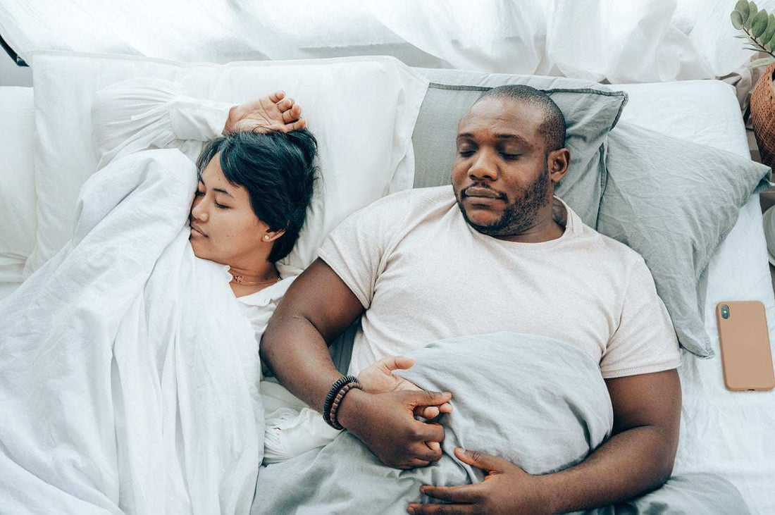  Soothe Organic Full Spectrum CBD Sleep Gummies with CBN and melatonin in amber glass jar on a dark nightstand with soft lighting