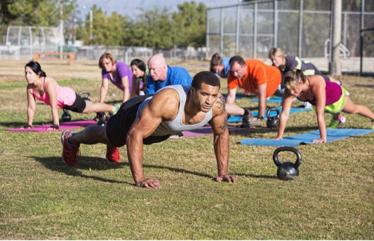 Women doing push-ups outdoors as part of an active fitness routine supported by organic CBD recovery