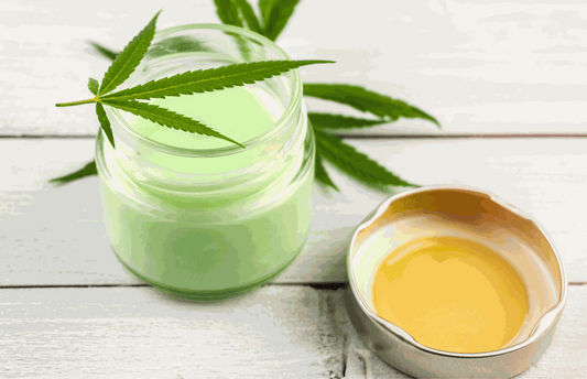 A jar of Soothe Organic USDA Certified Organic CBD salve with menthol resting on a wooden porch bench next to a rolled towel and a water bottle after a Wyoming trail run, representing topical CBD and menthol pain relief