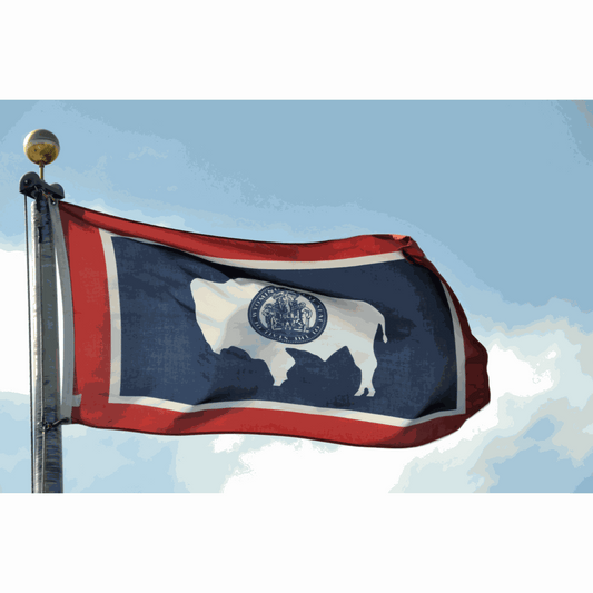 Assorted colorful hemp-derived Delta-9 THC gummies arranged on a wooden surface next to a Certificate of Analysis lab report, with Wyoming mountain scenery in the background — representing legal hemp Delta-9 gummies available in Wyoming.