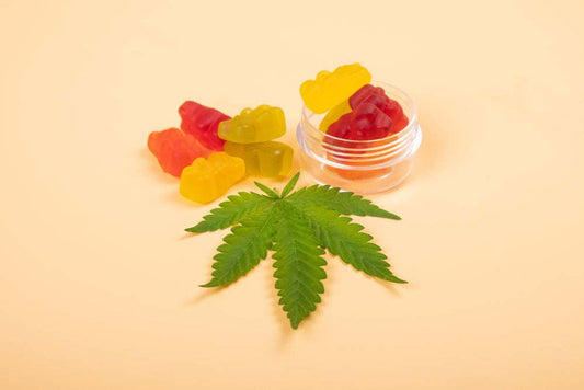A Soothe Organic Delta-9 THC hemp gummy on a wooden counter next to a published third-party lab report, illustrating careful Delta-9 gummy dosage