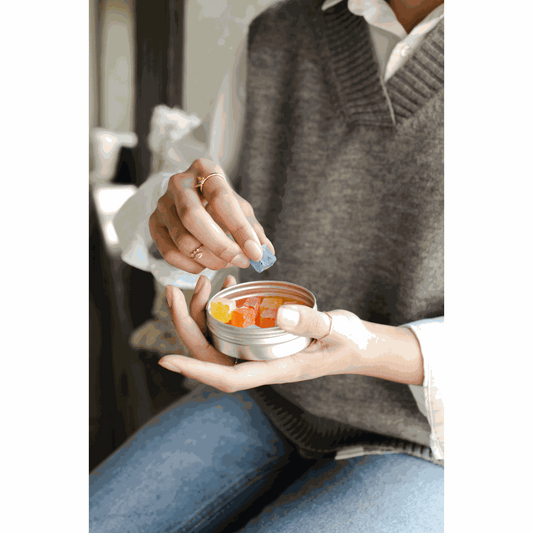 Soothe Organic Delta-9 THC sleep gummies in lavender-lemon and chamomile-berry flavors, displayed with a sleep tracker and journal on a wooden nightstand.