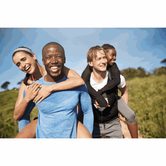 A small group of friends walking together on a Wyoming trail at golden hour, illustrating how social connection supports brain and heart health